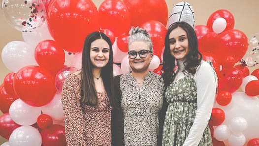 Janelle Reed and her daughters, Kassidy and Madison, at a volleyball banquet.