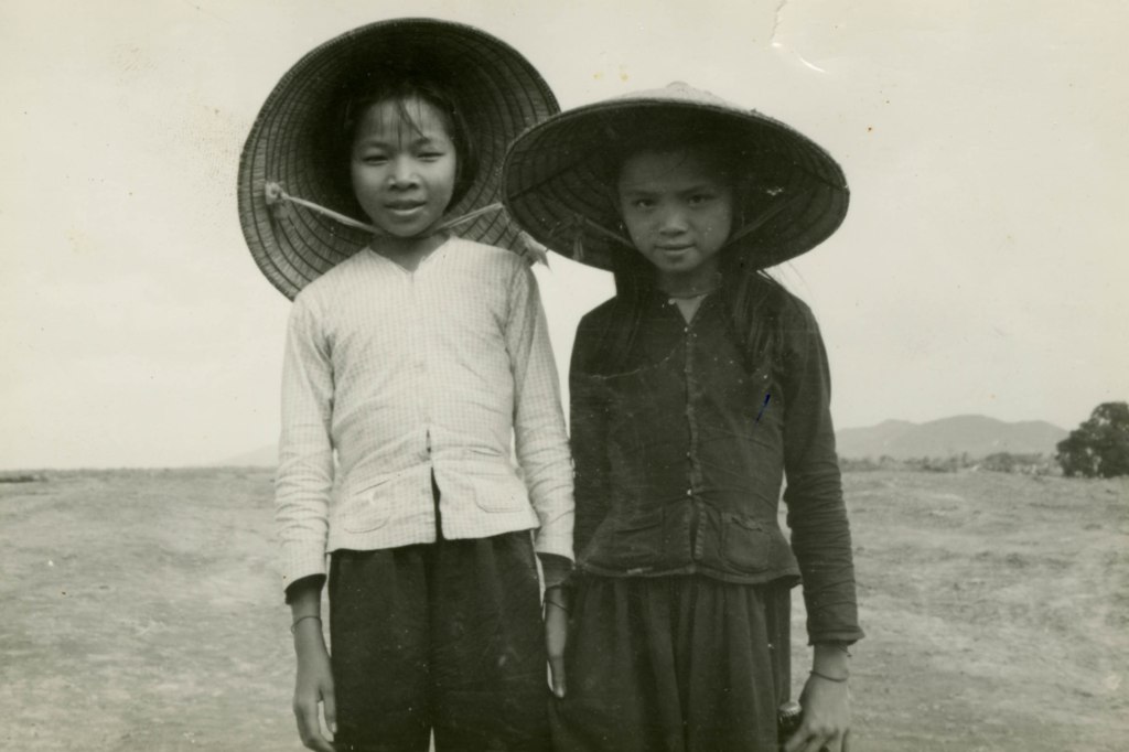 Image: Two Vietnamese girls pose for a picture.