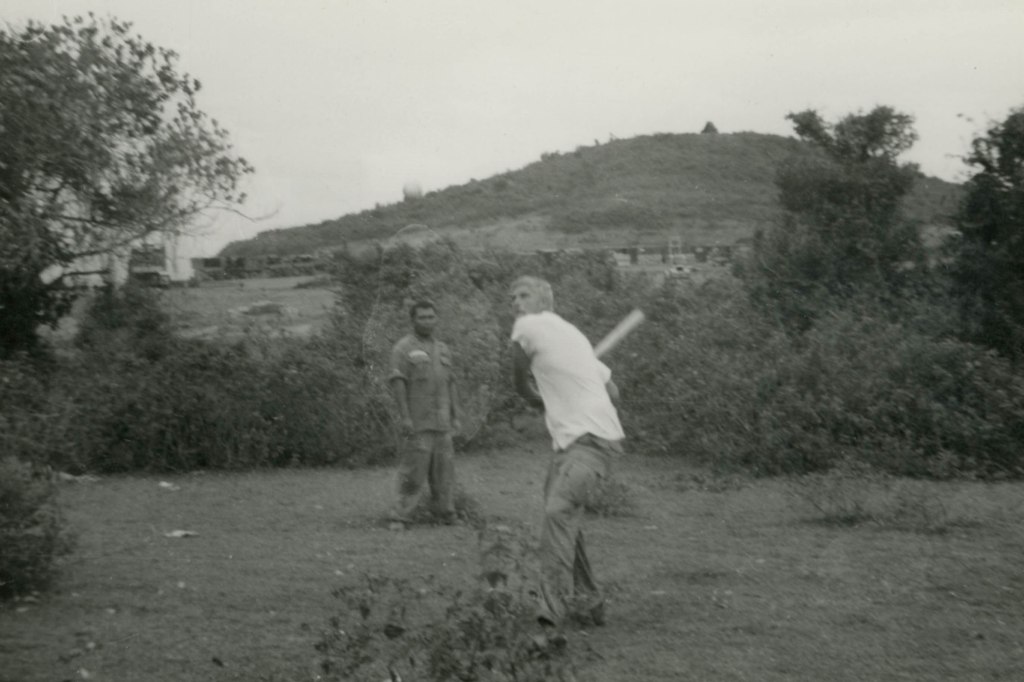 Image: A soldier stationed with Grant Townsend plays baseball with a makeshift bat in Vietnam.