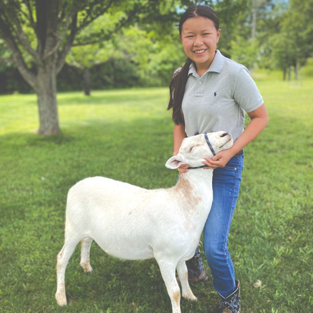 Anna Sweeton poses with her ewe, Rose.